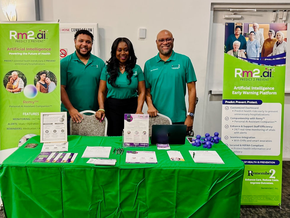Three people in green shirts smiling behind a booth with "Rm2.ai" banners promoting AI health solutions. Green tablecloth with flyers.