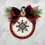 Thumbnail: Christmas ornament cross stitch with counted cross stitch snowflake pattern that is finished as a circle.