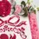 Thumbnail: Detail view of a coquette bow on a Valentine cross stitch pattern. Stitched on light linen cross stitch material.