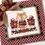 Thumbnail: Stitched example of fall cross stitch pattern. Cute fox in sweater between pumpkins, fall leaves in orange, green, burgundy.
