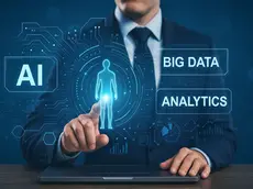Businessman in a suit interacts with a holographic display showing AI, Big Data, and Analytics on a blue tech-themed background.