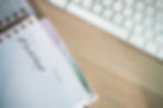 a planner on a desk next to a keyboard with #Do Not Forget written in it