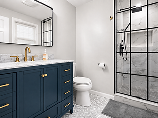 Walk-in steam shower with black-framed glass and marble-look tile in Marshfield, MA