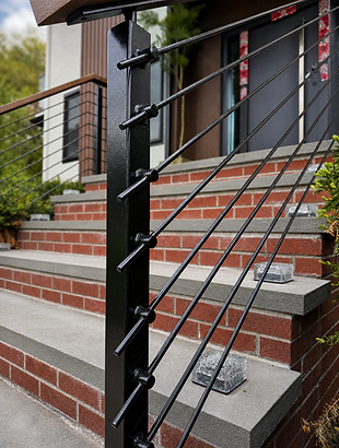 Black metal porch railing installed along brick front steps in Newton, MA