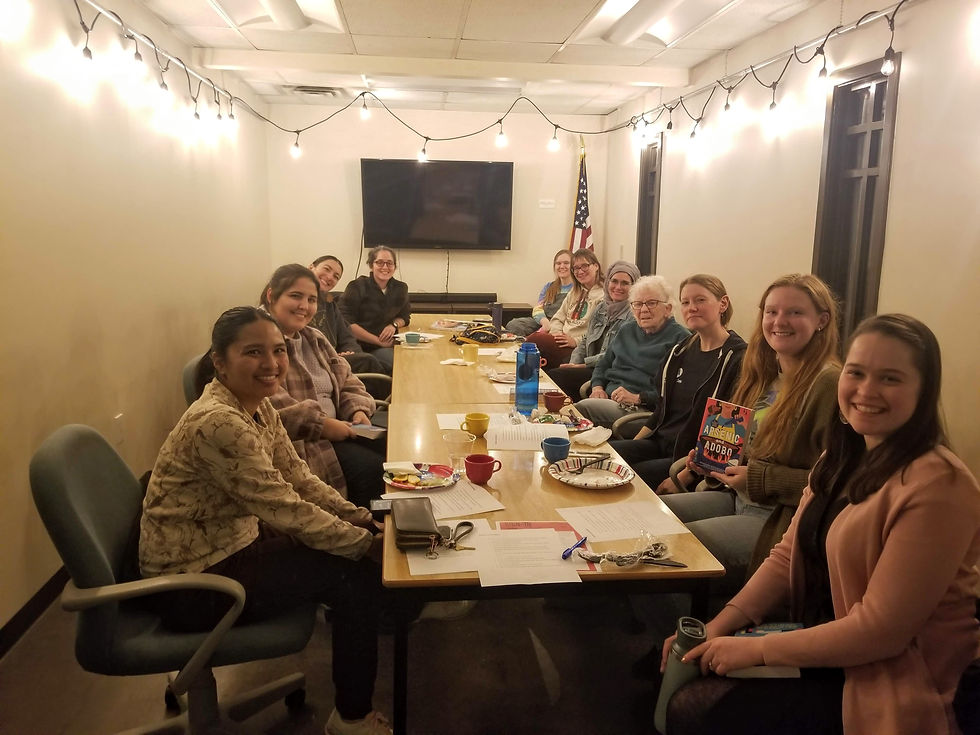 A group of people sitting around a table with food