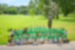 Large group of volunteers in an open field
