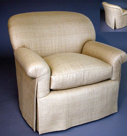 Cream custom upholstered armchair with tailored detailing