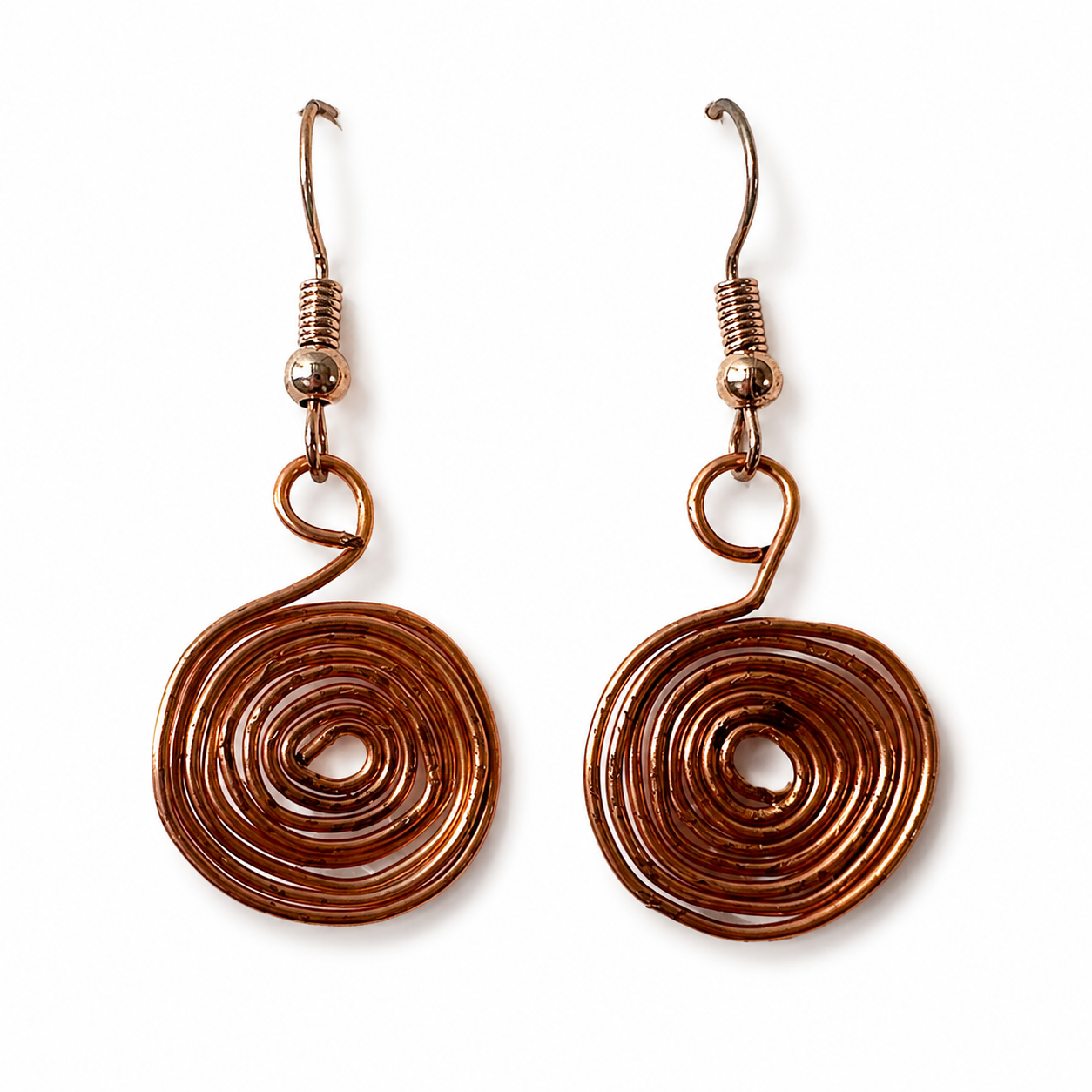 Handmade spiral wire earrings on white background