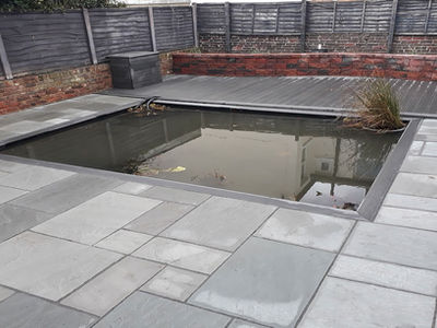 pond surrounded by a patio