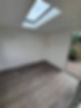 empty room with glass doors and skylight
