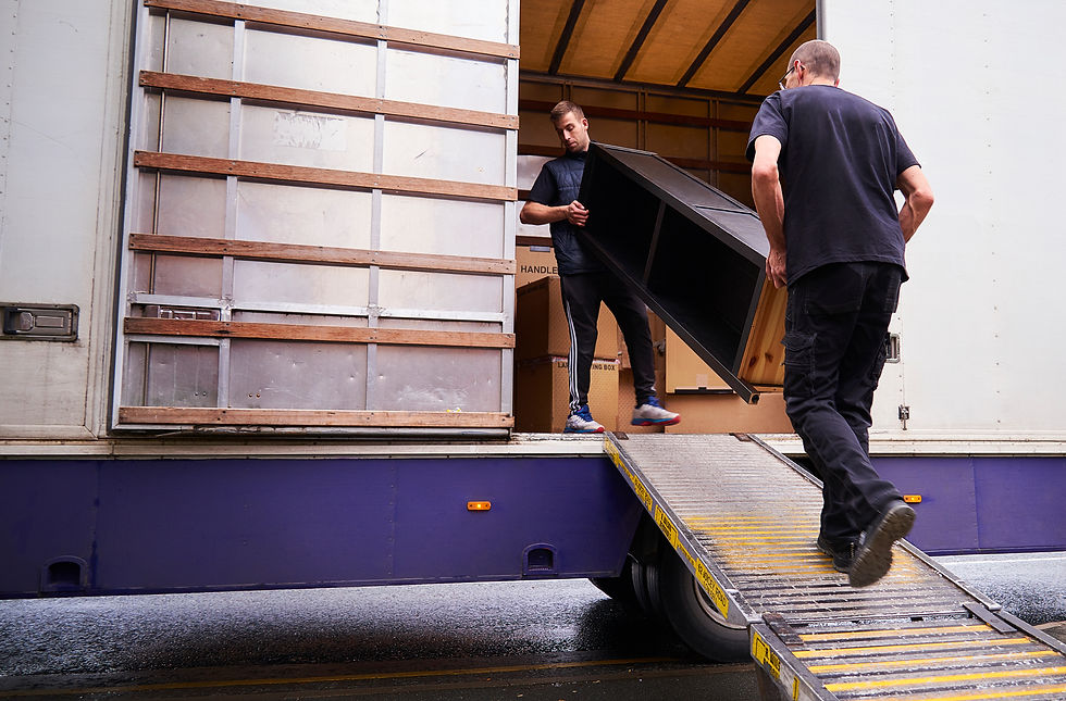 Two men carrying furniture into a truck