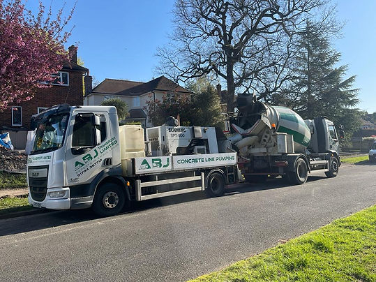 ABJ Transport concrete line pumping truck parked on a residential street