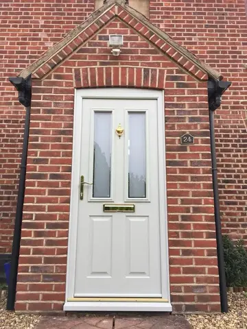 brick exterior of a house with white door
