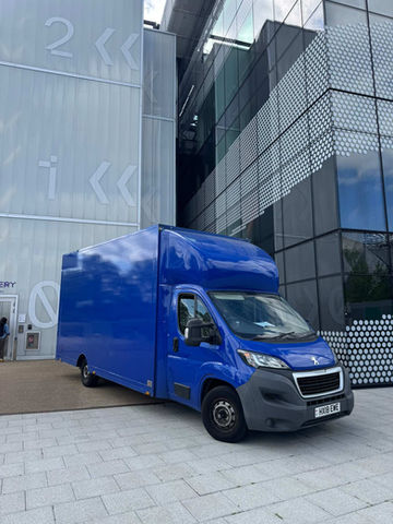 a blue truck parked outside a commercial building