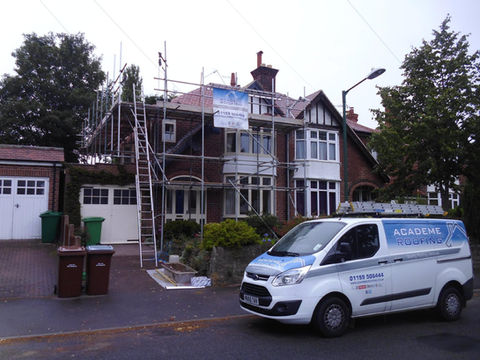 van parked in front of a house which is under renovation