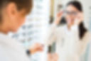 smiling woman trying eye glasses