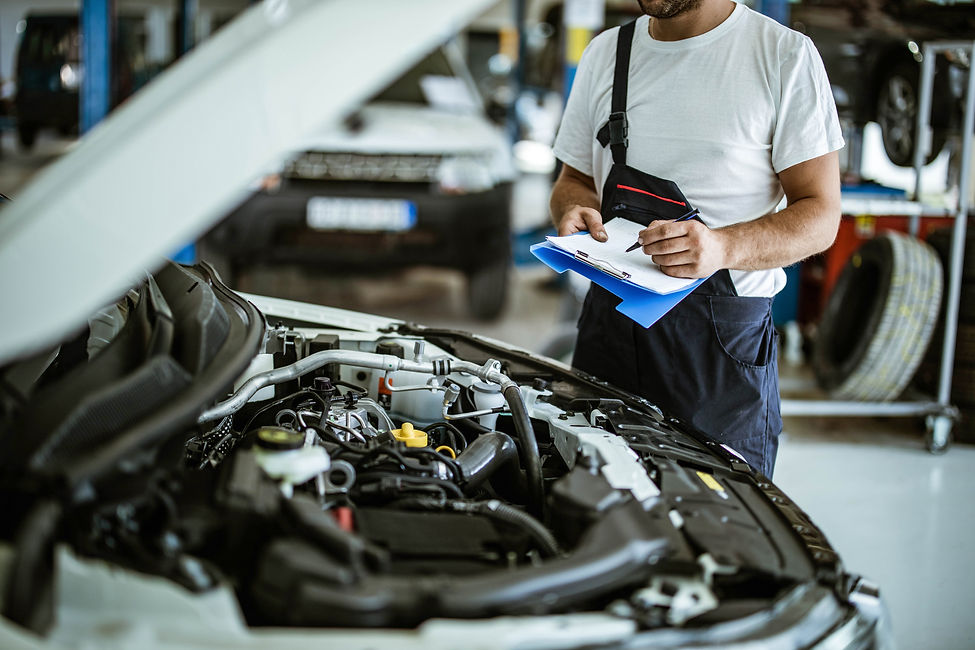 a mechanic's hand with clipboard