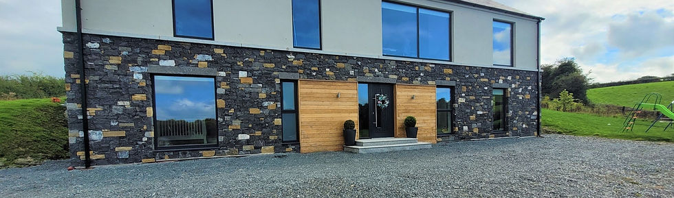 Modern two-story house with large blue-tinted windows, stone and wood facade