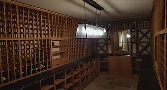 A dimly lit wine cellar with wooden racks holding bottles