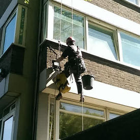 a worker repairing exterior wall of a building
