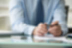 close-up image of a person's hand while using pen