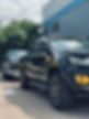 a black truck towing a car