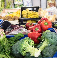 fruits and vegetables in baskets in a shop