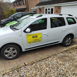 a white cab parked in front of garage