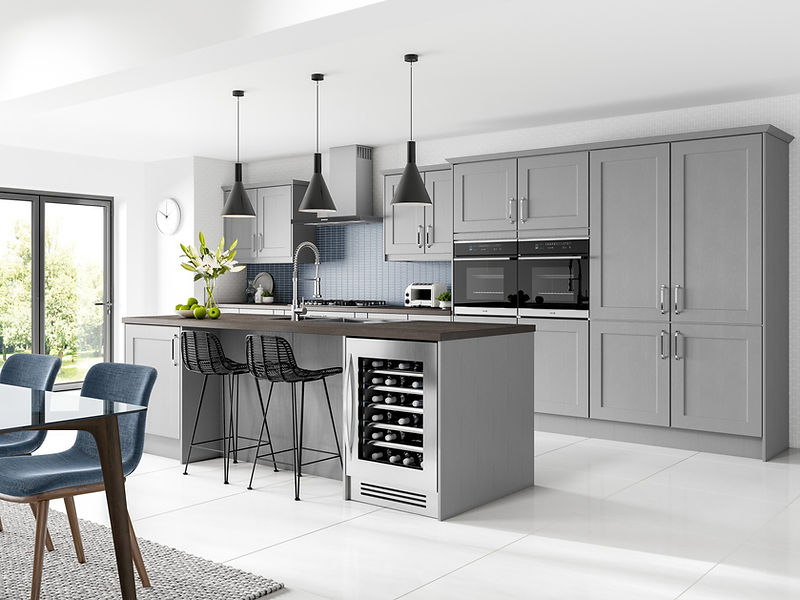Modern kitchen with gray cabinets, large island with a dark wooden countertop