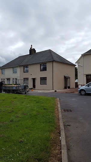exterior view of a house with vehicles parked on road