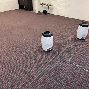 Carpeted floor with white machines