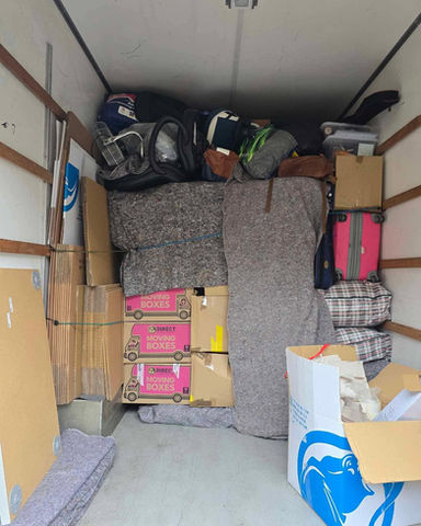 A moving truck filled with numerous boxes