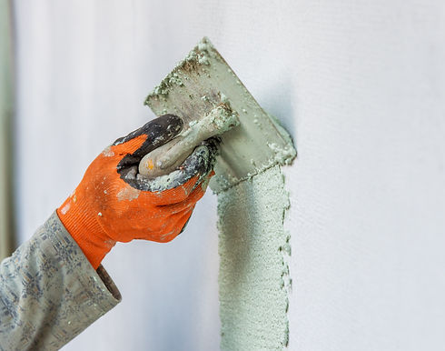 a worker plastering wall