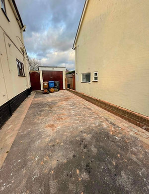 A narrow driveway between two houses