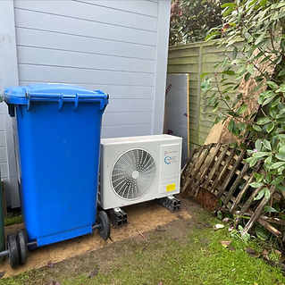 a blue dustbin and an air conditioning unit