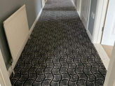 Dark carpeted staircase.