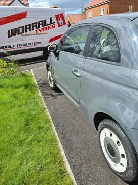 a van parked in front of a car on road