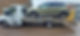 green car on flatbed trailer