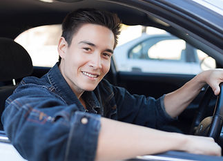 a smiling man driving car