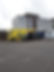 yellow and black trucks parked in front of a building