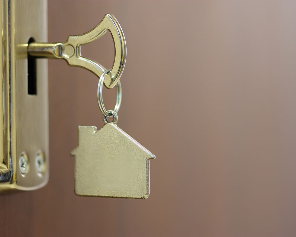 A key with a house keyring in the door lock