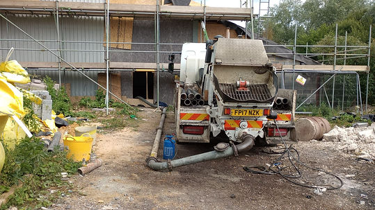 Concrete pump truck parked at an active building construction site