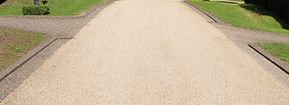 A wide pathway bordered by grass on both sides