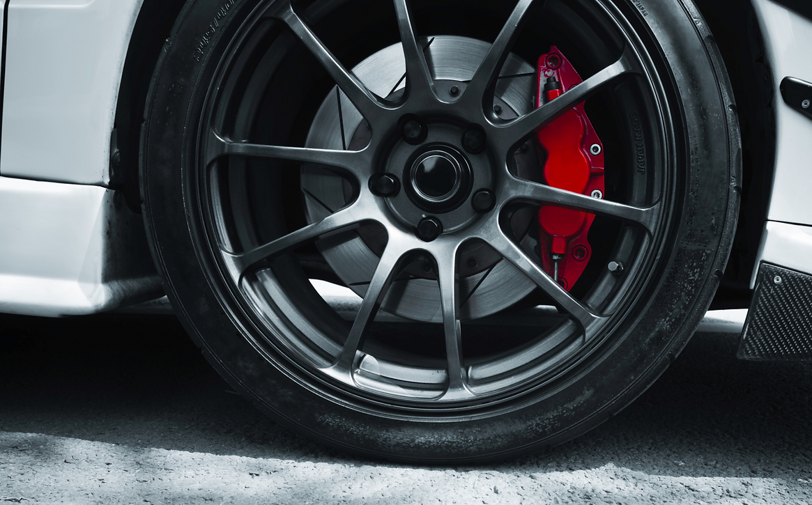 close-up image of car wheel with red brake