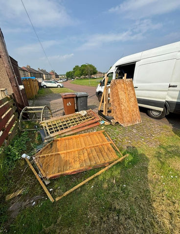 pile of fly tipped rubbish including fence panel before clear up