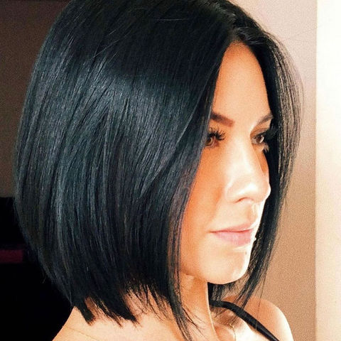 Side view of a woman with a long angled bob cut on straight back hair
