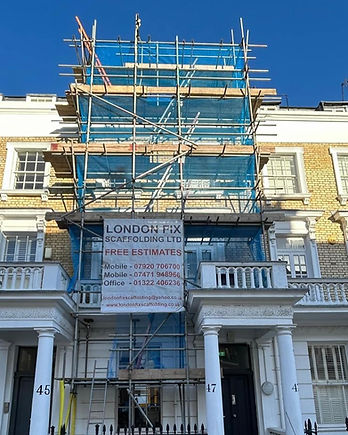 A scaffolding structure on a house and London Fix Scaffolding Ltd banner
