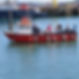 A red and white fishing boat named "Mary Ellen II" with passengers onboard is docked in a 