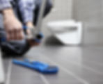 close-up image of a plumber's hand while fixing pipe in bathroom