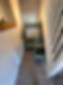 a green dresser and radiator below the staircase
